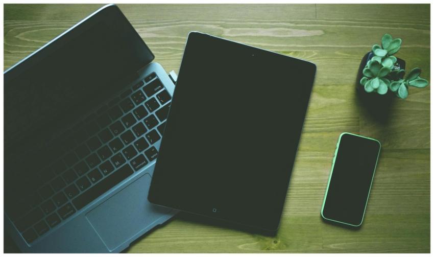 A top-down view of a workspace featuring a laptop,