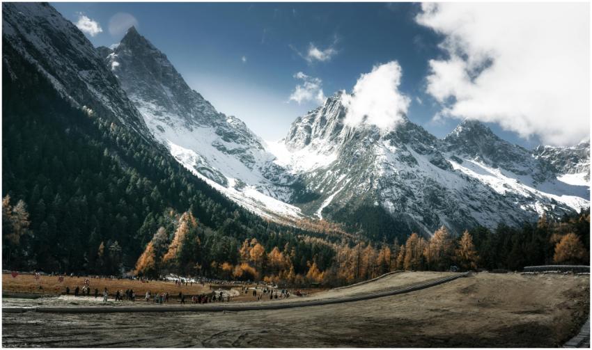 Majestic snow-capped mountains with an autumn fore