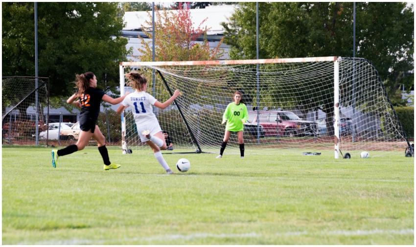 Women athletes competing in a lively soccer game w