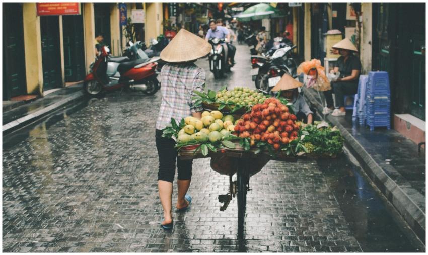 A woman sells fresh fruits in a Đống Đa street mar
