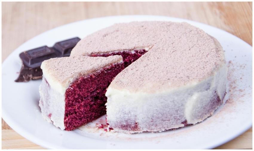 Sliced red velvet cake with cream cheese frosting