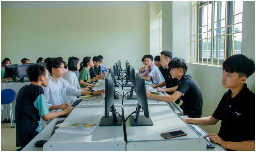 Diverse group of students studying in a computer-e