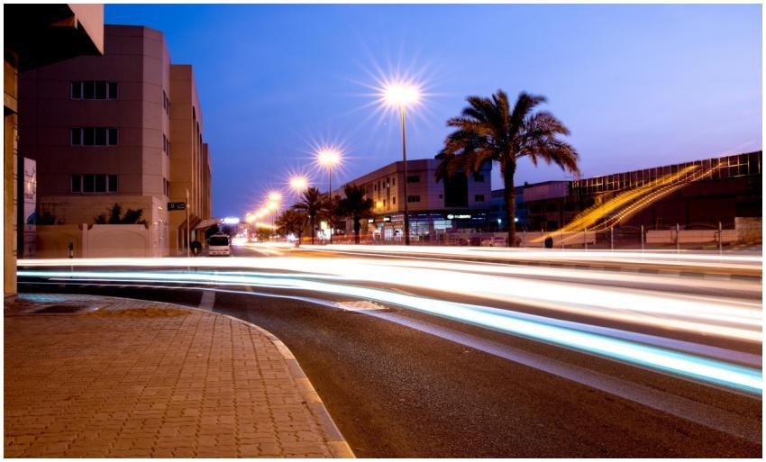 An urban evening scene capturing light trails on a
