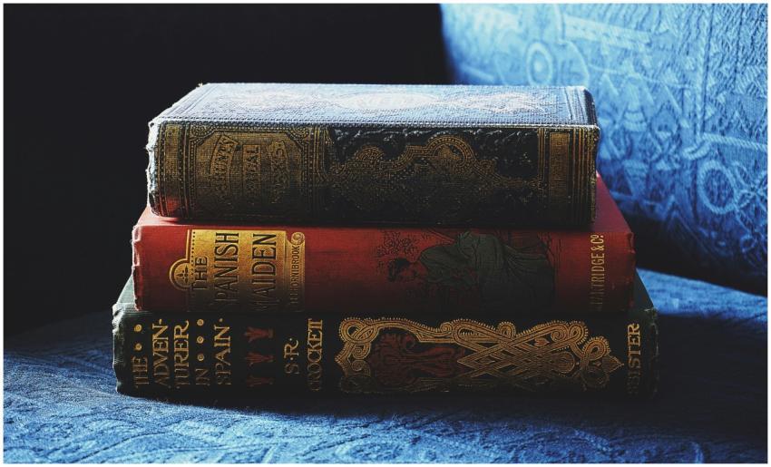 A stack of antique books with decorative bindings