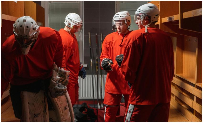 Ice hockey team in red uniforms preparing in the l