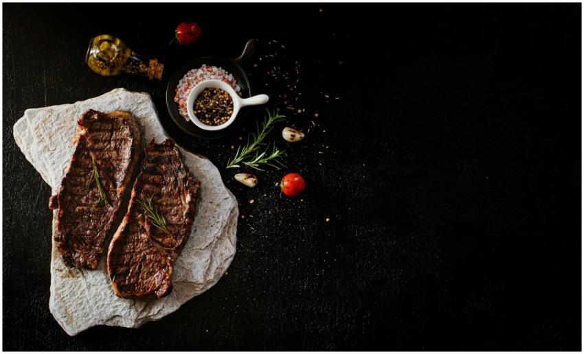 Delicious grilled steak served with rosemary, garl
