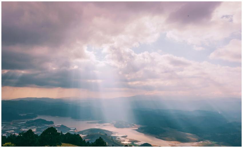 Gentle sunbeams breaking through a cloudy sky over