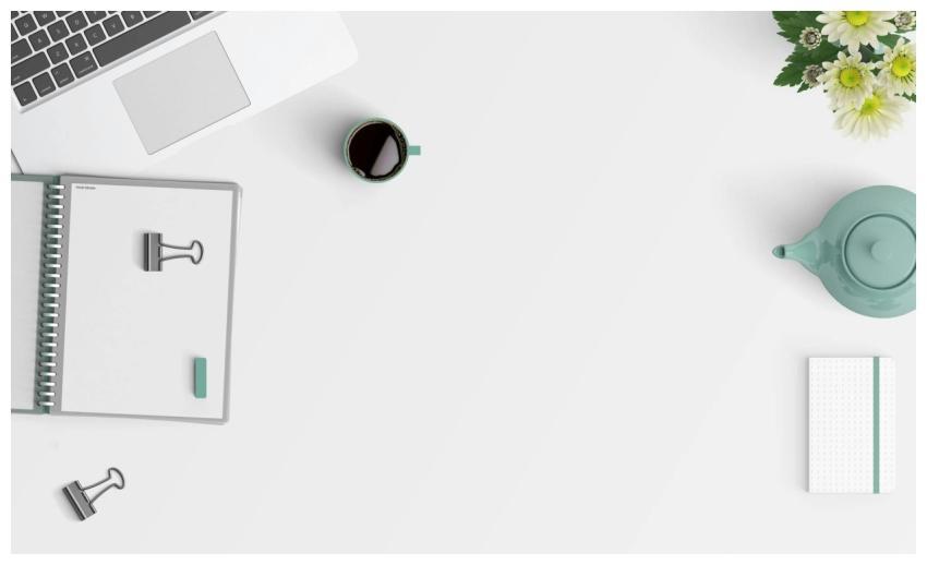 Clean minimalist workspace with a laptop, coffee,