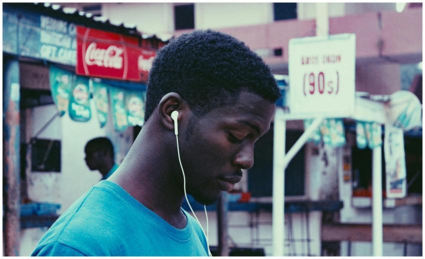Profile view of a young man wearing earphones on a