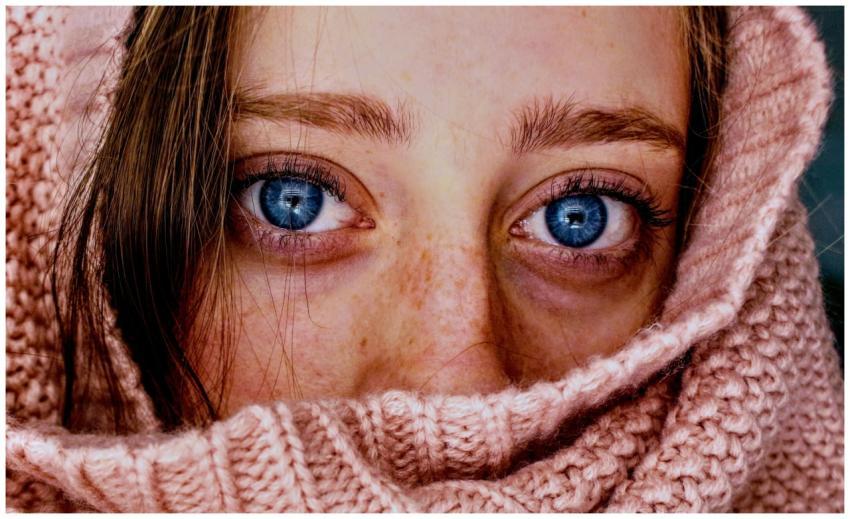 Intense close-up of a woman's blue eyes wrapped in