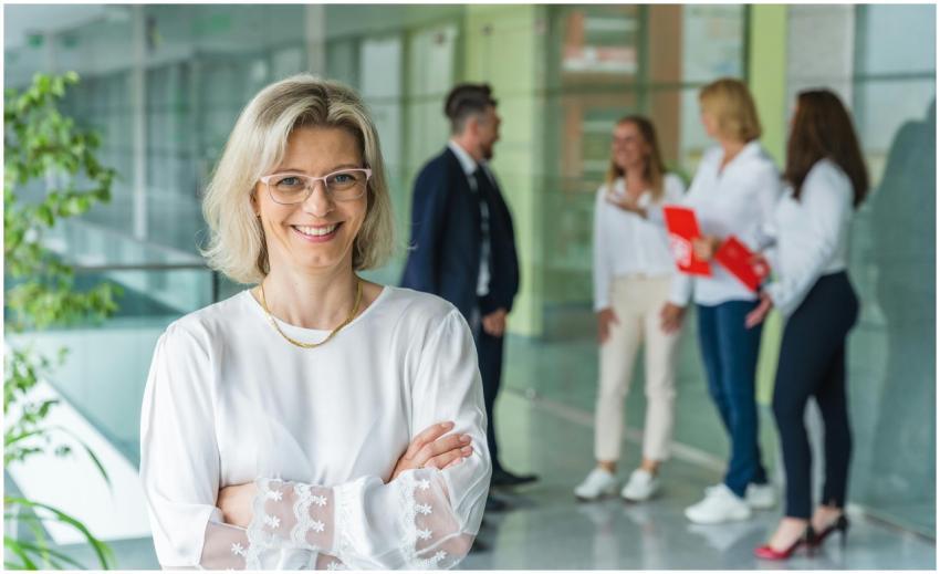 Smiling businesswoman with crossed arms in a brigh