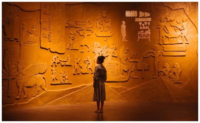 Back view of anonymous female traveler standing ne