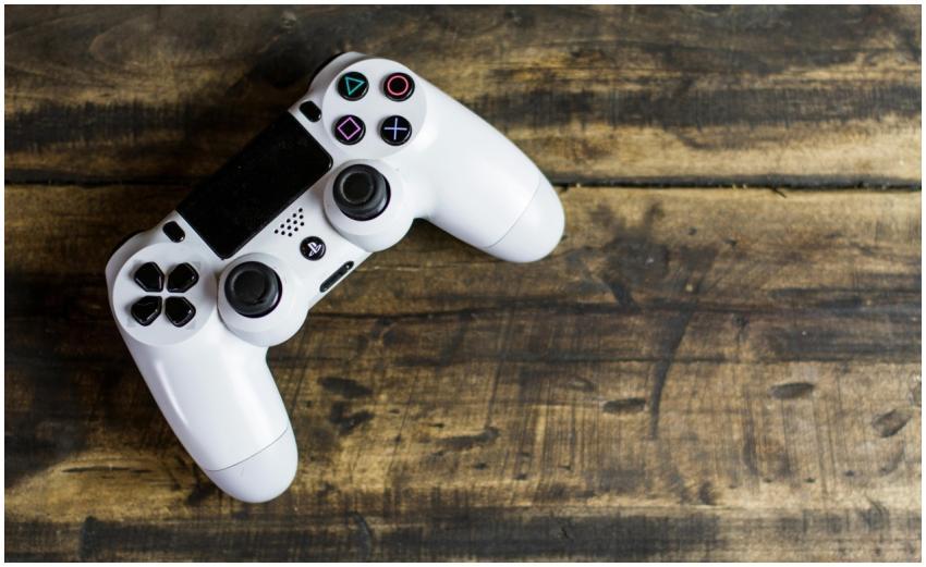 White game controller resting on a rustic wooden s