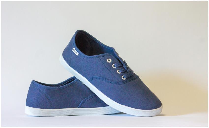 Pair of stylish blue canvas shoes with white soles