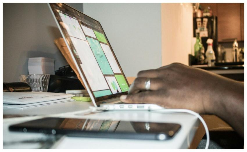 Focused setup of person working on a laptop in a h