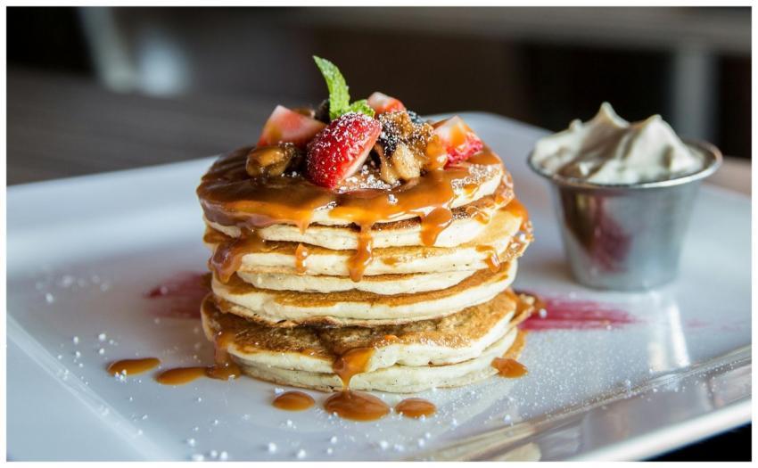 Mouthwatering pancakes with strawberries, nuts, an