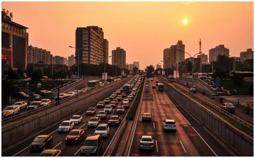 A bustling urban highway with heavy traffic under