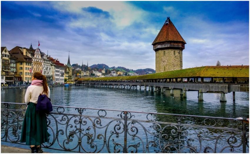 Traveler admires Chapel Bridge and Water Tower in