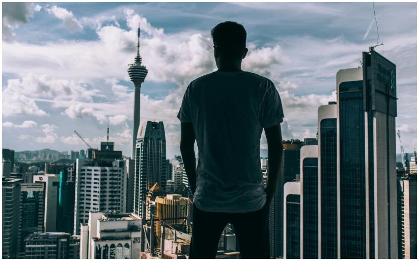 A silhouette of a man overlooking the Kuala Lumpur