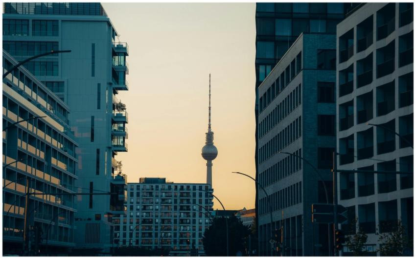 Berlin TV Tower visible between modern buildings a
