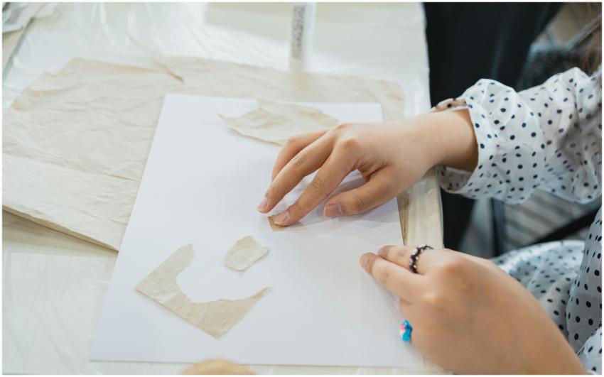 Close-up of an art student crafting with paper in