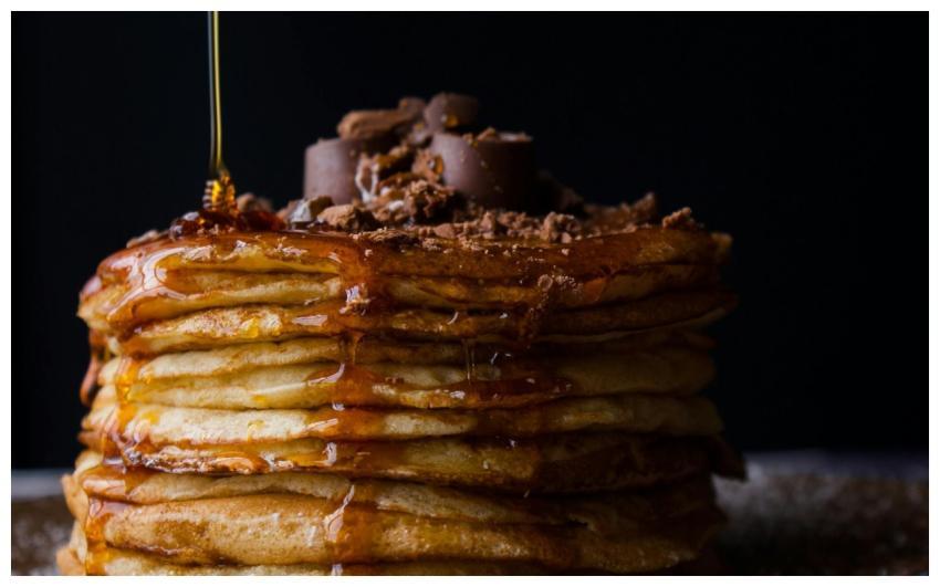 Mouthwatering stack of pancakes topped with chocol