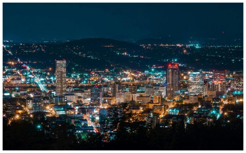 A stunning aerial view of a city skyline illuminat