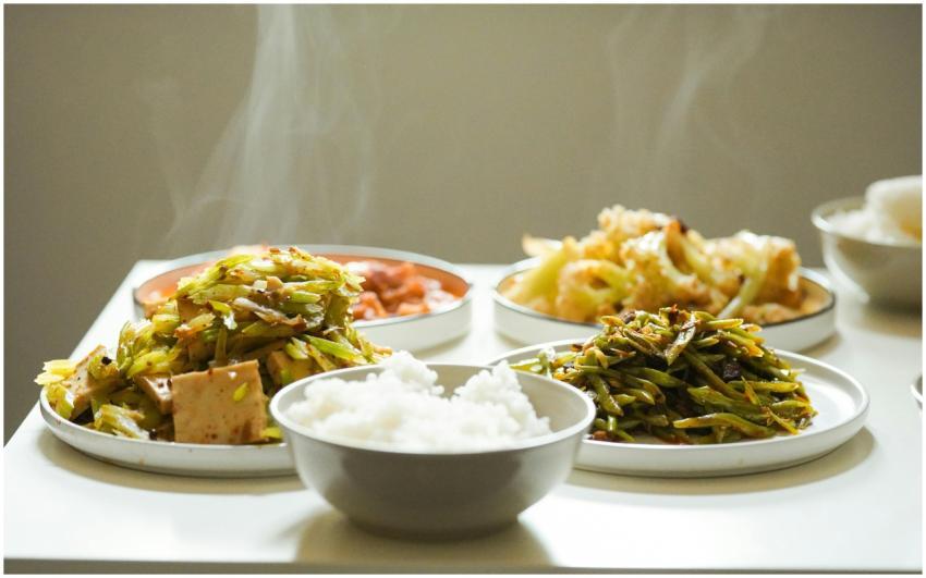 Capture of steaming Asian dishes featuring a varie