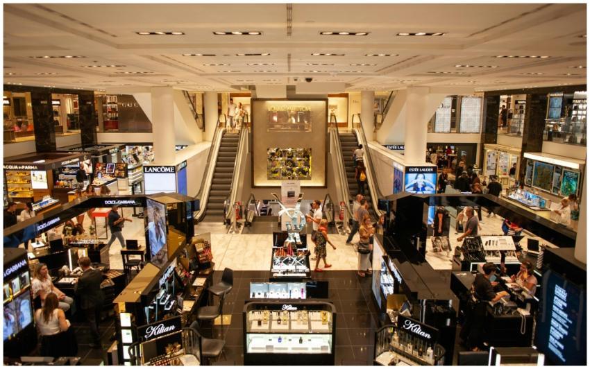 A bustling scene inside a modern shopping mall wit