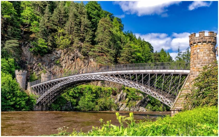 Scenic view of a historic bridge amidst lush green