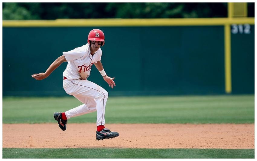 Athlete in action running on baseball field, weari