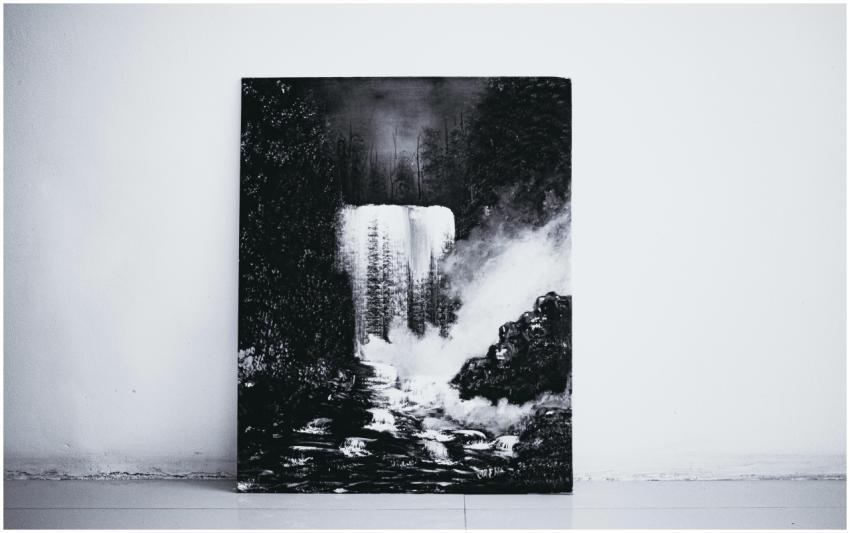 A striking black and white painting of a waterfall