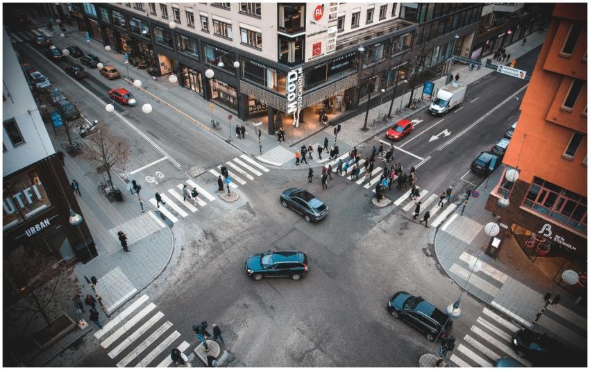 A bustling Stockholm street intersection with pede