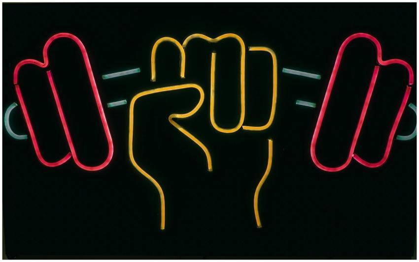 Colorful neon sign of a fist holding dumbbells, sh