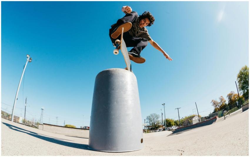 Skateboarder performing a trick in a sunny outdoor