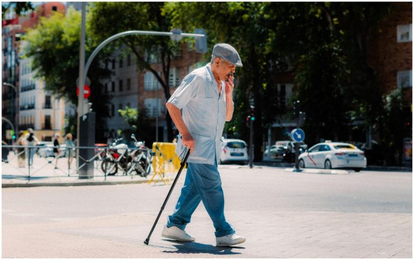 Senior adult using a cane while crossing a street