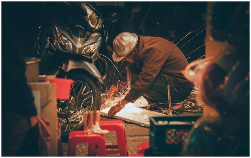 Artisan welding in a workshop, creating sparks bes