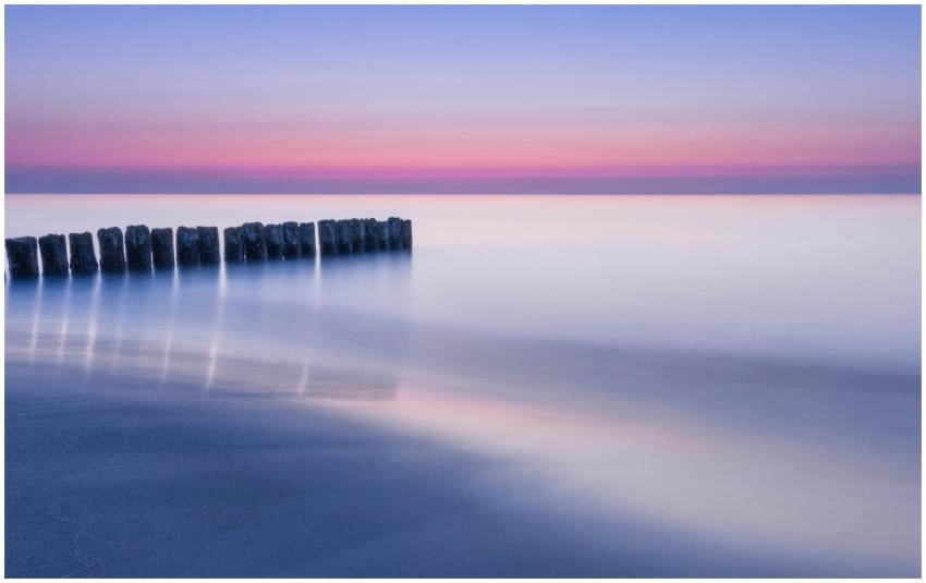 A tranquil ocean scene at twilight with soft paste