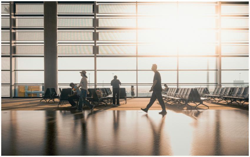 Silhouetted figures move through a sunlit Shanghai