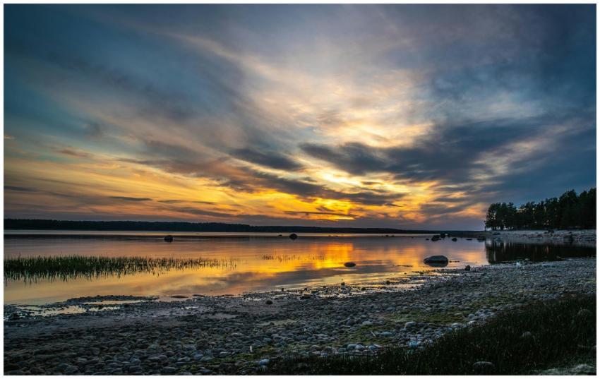 A breathtaking sunset over a calm lake, reflecting