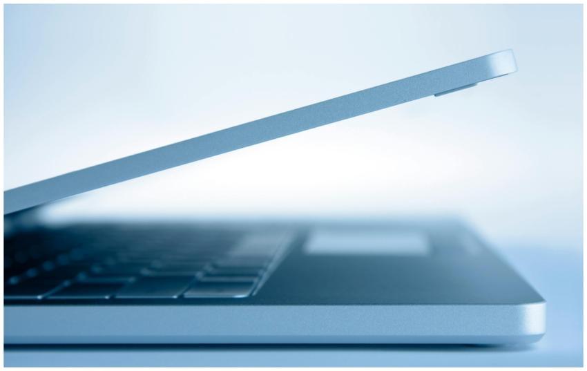 Profile view of a sleek modern laptop in a minimal