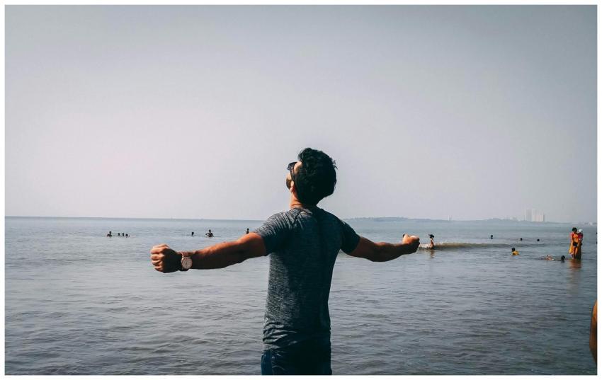 A man with open arms embracing freedom on a sunny