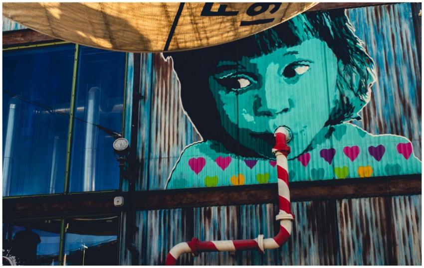 Colorful mural depicting a child with a pipe, show