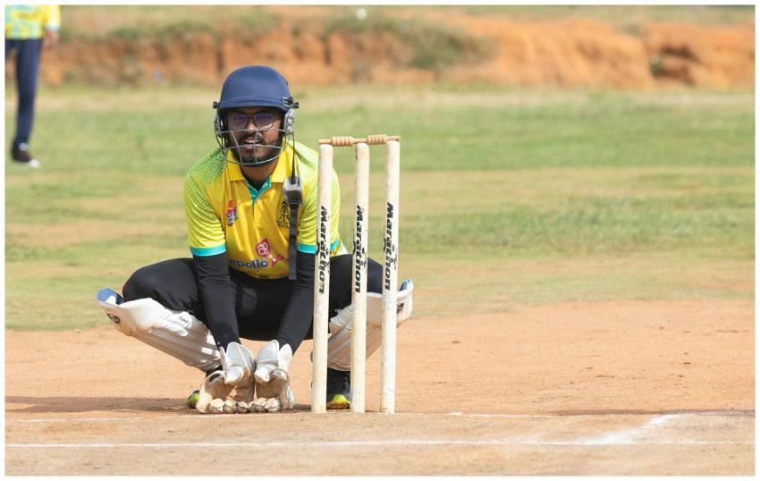 Cricket wicketkeeper crouching behind stumps durin