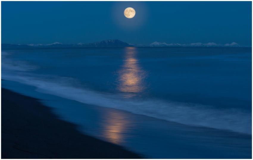 Tranquil night beach scenery with the full moon re