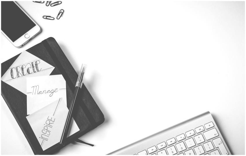 Minimalist flat lay of an office desk with noteboo