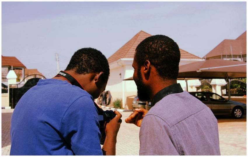 Two friends enjoy an outdoor photoshoot on a sunny