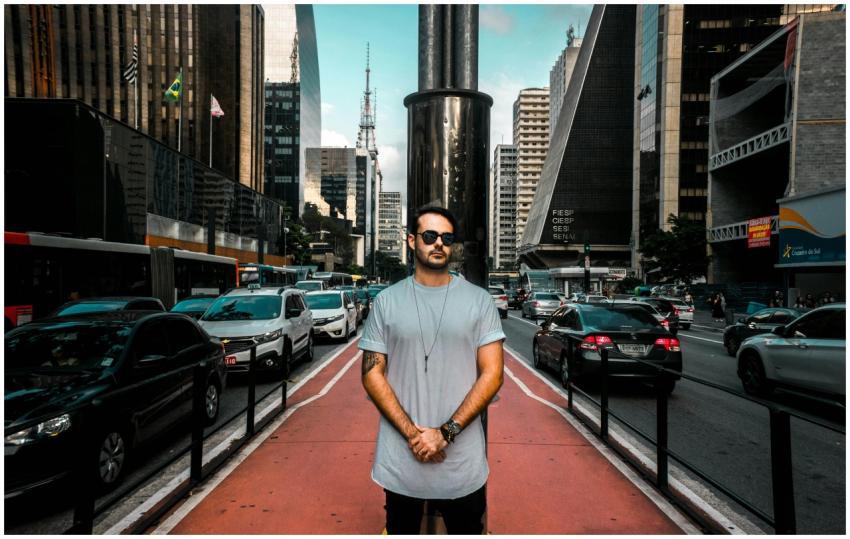 A man stands confidently on a bustling city street