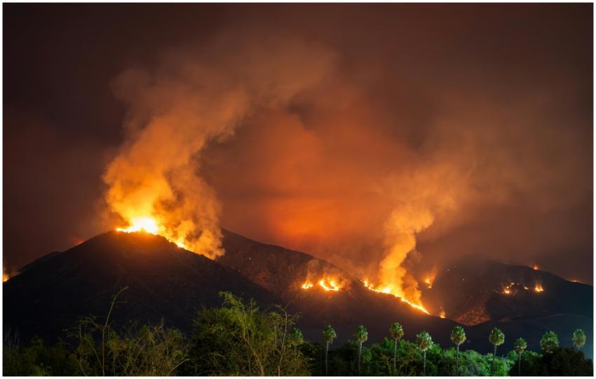 Intense wildfire scene at night in Redlands, CA wi
