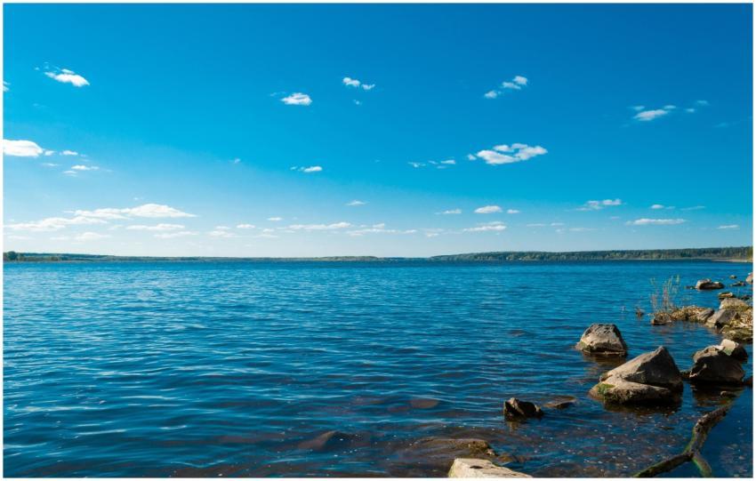 Serene view of a blue lake with rocky shore under